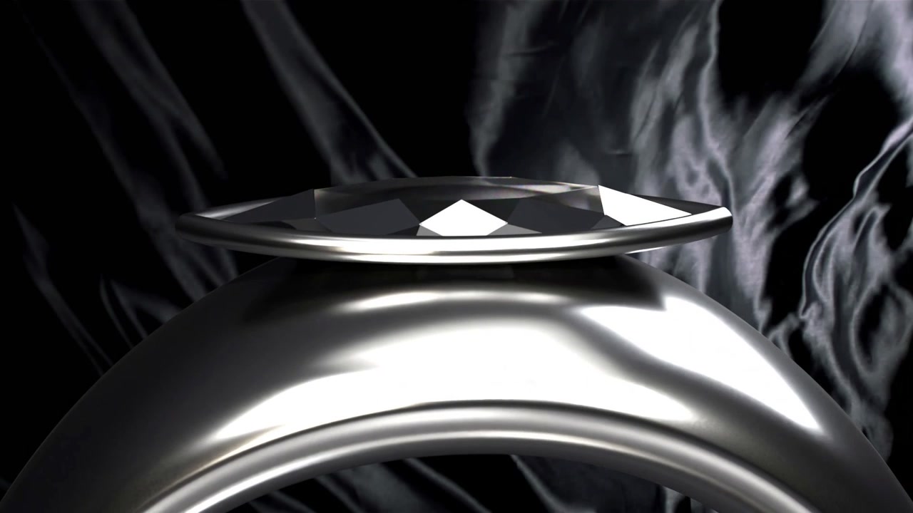 Camera pulling back and tilting, revealing polished ring on black satin drape highlighting facets