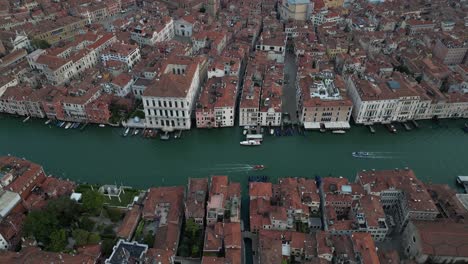 top-down aerial shot of historic buildings lining venice's grand canal.