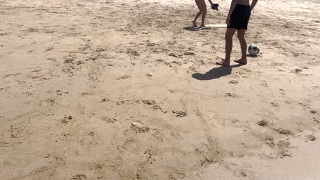 Two-siblings-immerse-themselves-in-pure-joy-as-they-play-together-on-the-sun-drenched-sandy-beach-of-Caparica