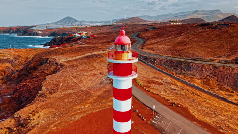 drone view of a colorful lighthouse on gran canaria's rugged coastline