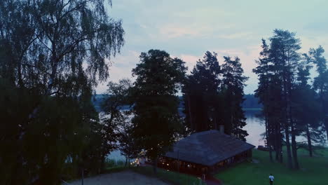 Luftdrohne-Schoss-über-Waldwälder,-Die-Einen-Ruhigen,-Ruhigen-See-Umgeben,-Mit-Weißen-Wolken,-Die-Sich-Auf-Der-Wasseroberfläche-Spiegeln