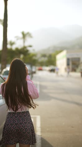 woman taking photo on a city street