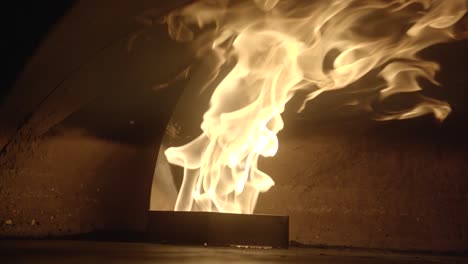 dolly shot brick wood oven with big flame slow motion detail