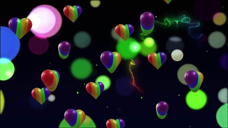 Animazione di cuori arcobaleno sopra punti luce su sfondo nero.