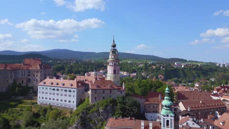 Marvelous-aerial-top-view-flight-tower-and-church,-Krumlov-Cesky-castle-on-the-hill-castlein-in-czech-republic-in-Europe,-summer-of-2023