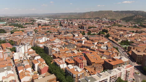 colorful rooftops of madrid living buildings and narrow streets, aerial descend view