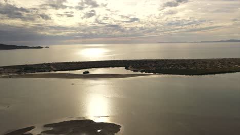 Flight-over-peninsula-at-sunset