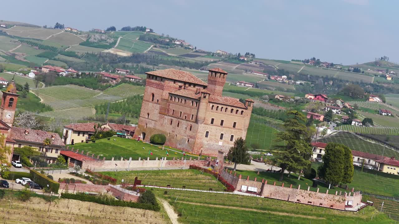 Tilting dynamic aerial landscape of Italian countryside and Grinzane Cavour Castle