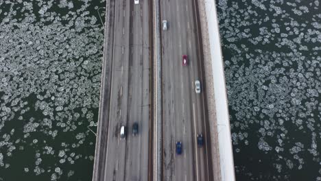 rare iceberg circular fungi algae bubbles headed west at a birds eye view over a quiet vintage quesnel bridge traffic north and south over the north saskatchewan river edmonton alberta canada 2-3