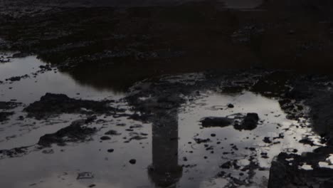 lighthouse reflection on pond tilting up to reveal on cliff edge