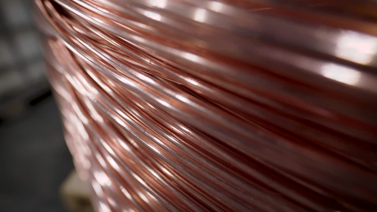 Copper rod. Thick copper wire coiled into a huge bobbin. Copper is one of the rare metals used everywhere