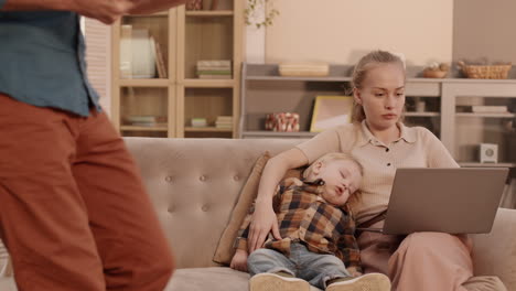 caucasian parents talking while son sleeping