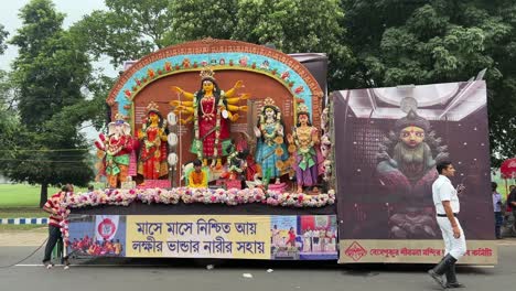 profile view of durga idol getting last checkups before heading towards carnival procession at red road in kolkata, india.