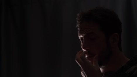 A man picking his nose to get rid of excess mucus caused by illness