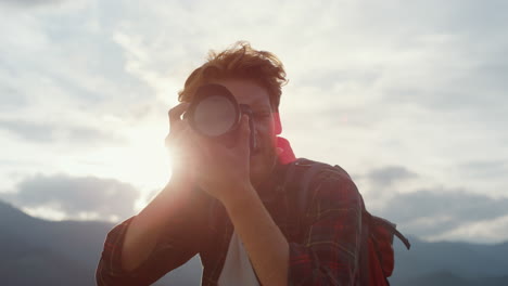 Closeup-inspired-photographer-film-on-camera.-Photography-pro-shoot-mountains.