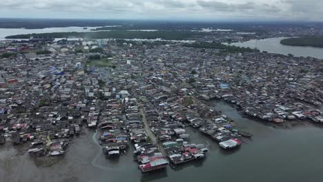 aerial top shot flyaway over slums of stilt houses in colombia