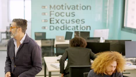 Coworkers chatting distracted until the boss arrives