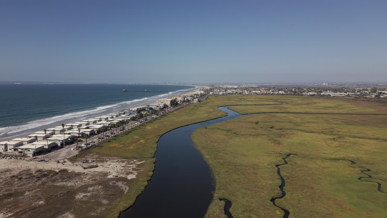 Drone view of beach homes in Imperial Beach next to the Tijuana River. Drone backwards shot
