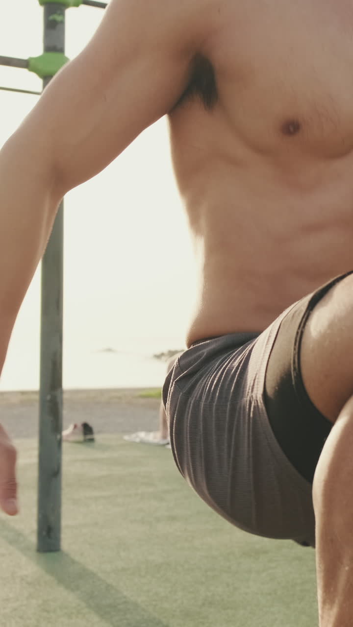 Shirtless man exercising outdoors