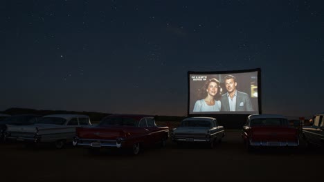 a magical drive-in cinema experience under the stars featuring iconic film moments in a nostalgic setting with classic cars aligned for a perfect night out