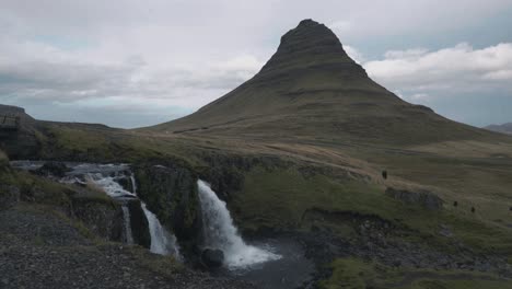 static shot of a waterfall with the mountain kirkjufell in iceland