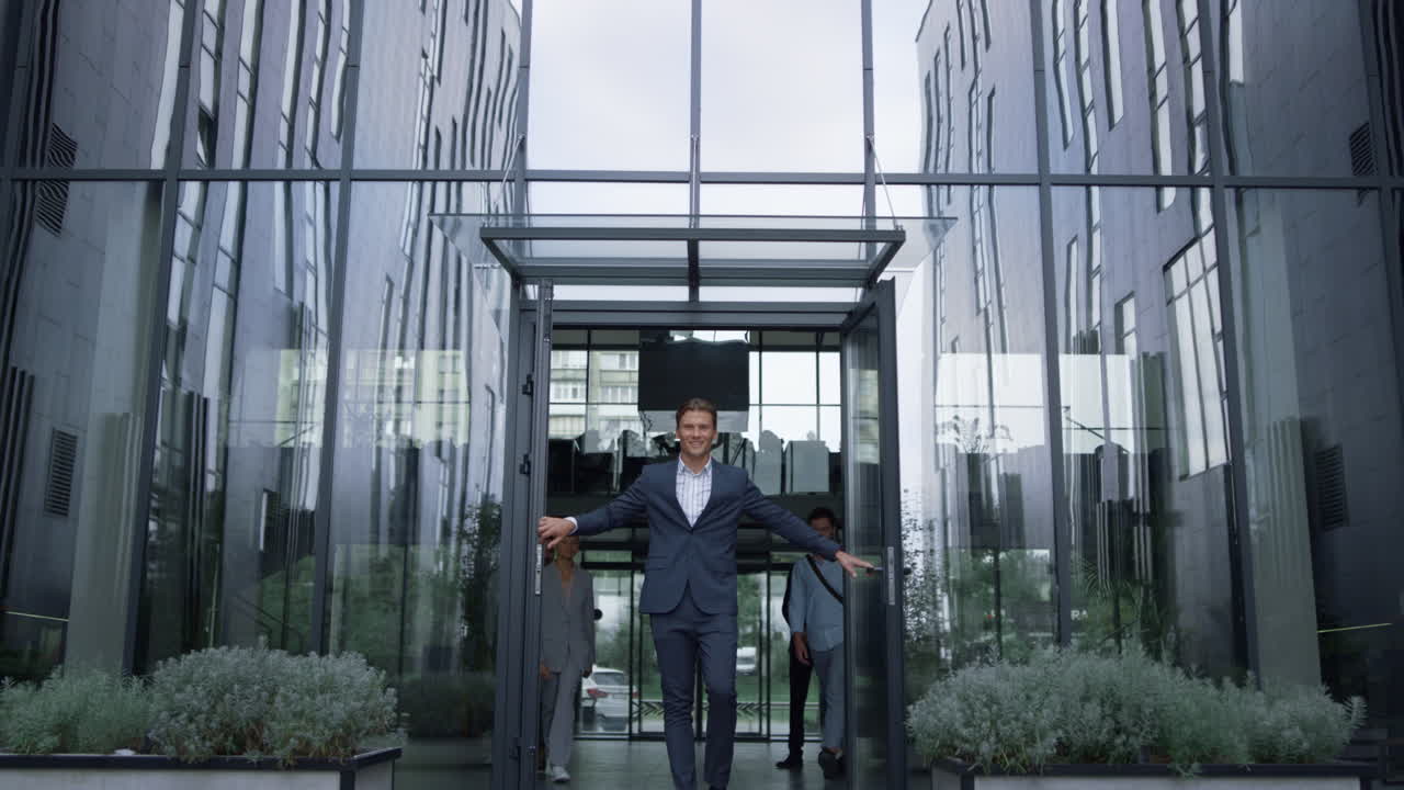 hombre de negocios exitoso de pie en la puerta del centro de la oficina. equipo de contenido salir del edificio