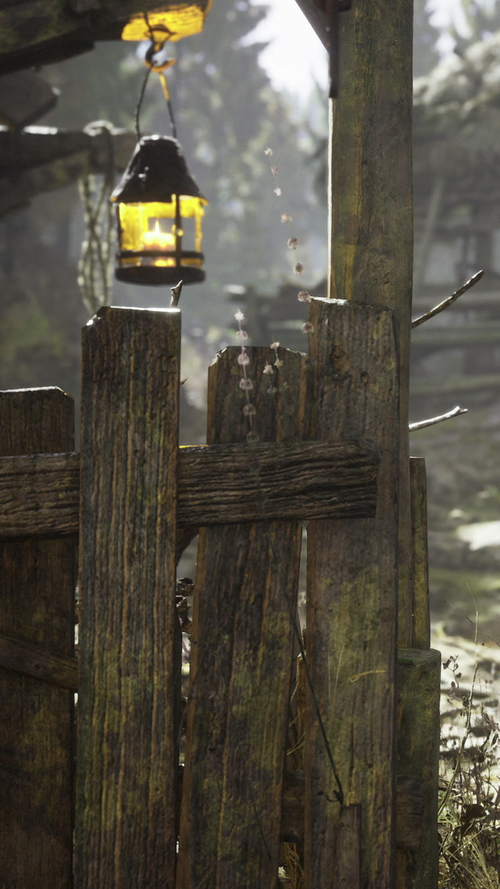 Lantern hanging near wooden fence in forest area during daylight hours