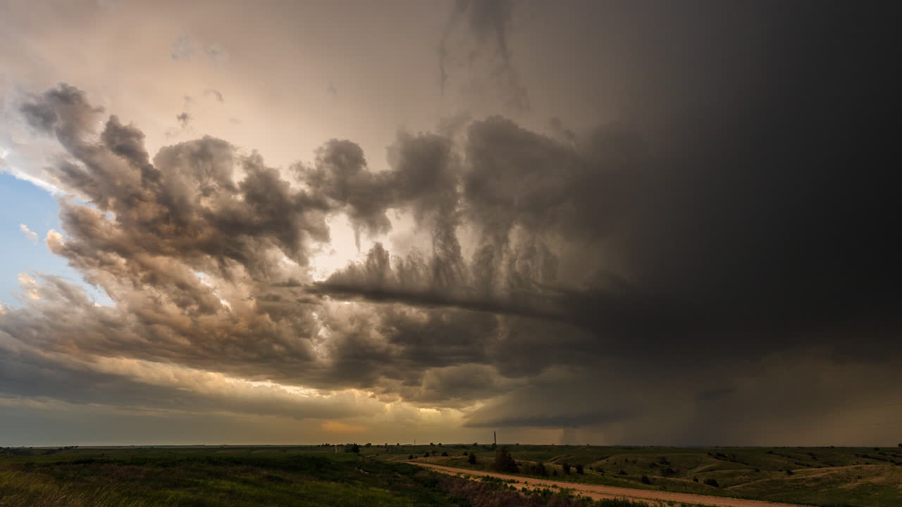 Lightning storm clouds drifting into late evening light and color