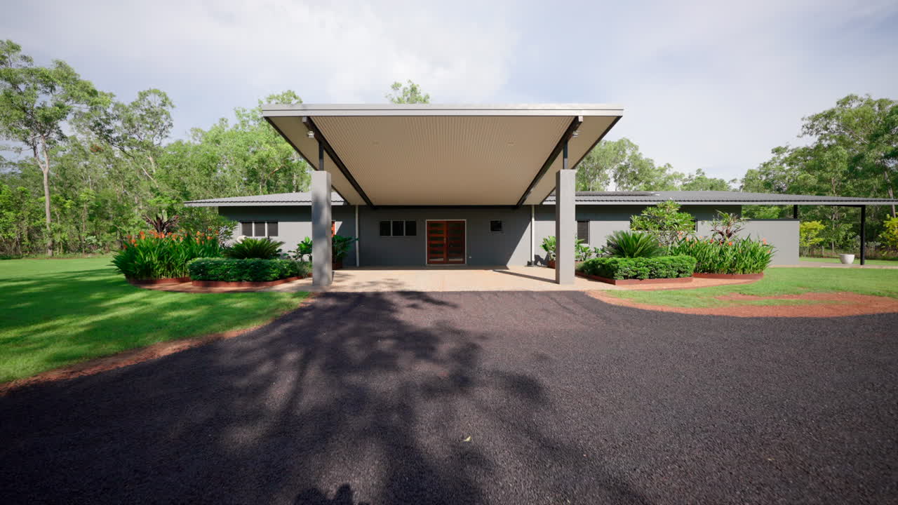 vista frontal de uma casa tropical de design moderno com entrada de betume
