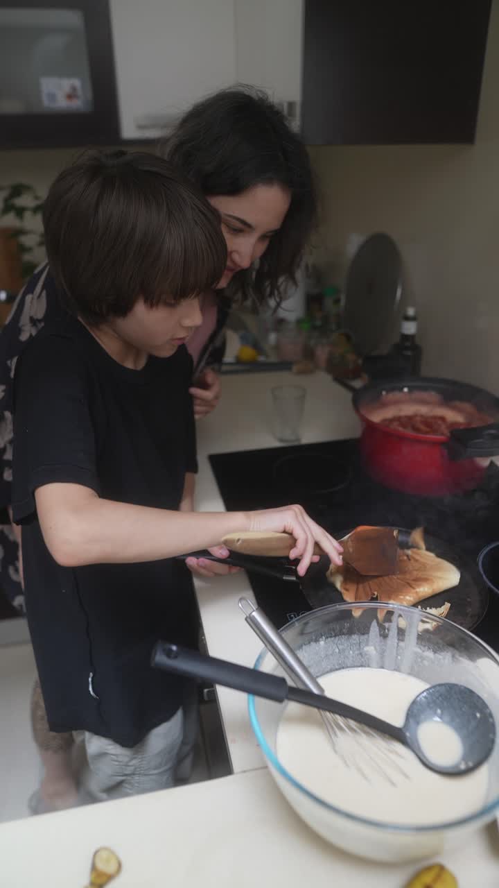 Mother and Son Cooking Pancakes Together