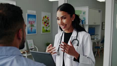 a friendly doctor consults a patient in a modern clinic. medium camera angle video