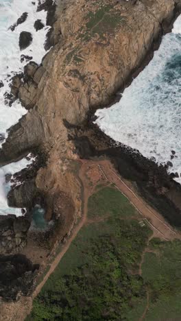 cliffs at punta cometa, mazunte, oaxaca, mexico, aerial view in vertical mode