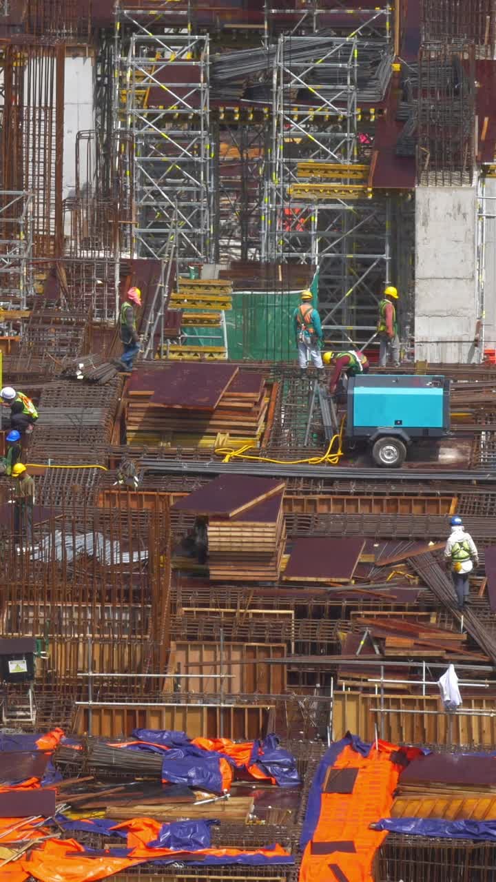 Busy Construction Site with Workers and Concrete Pump