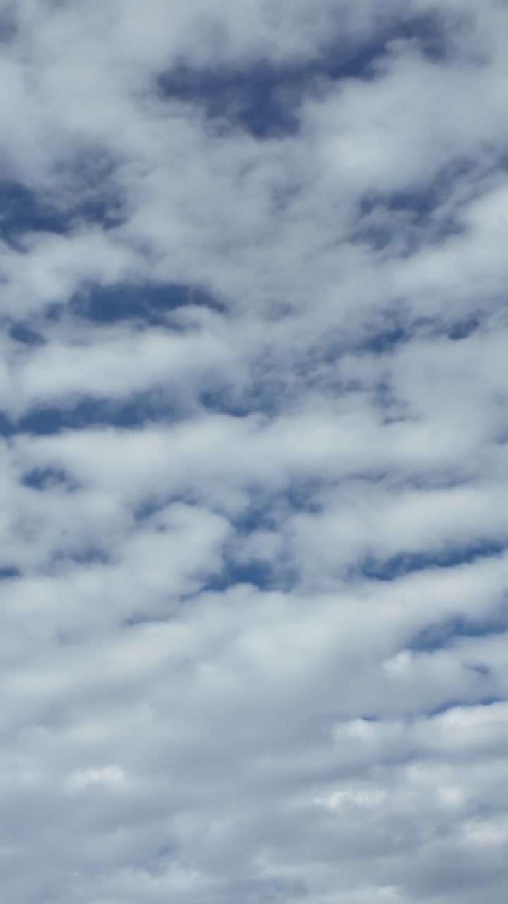 White Fluffy Clouds Drifting Across a Blue Sky