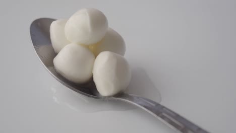 close up of mozzarella cheese on a spoon