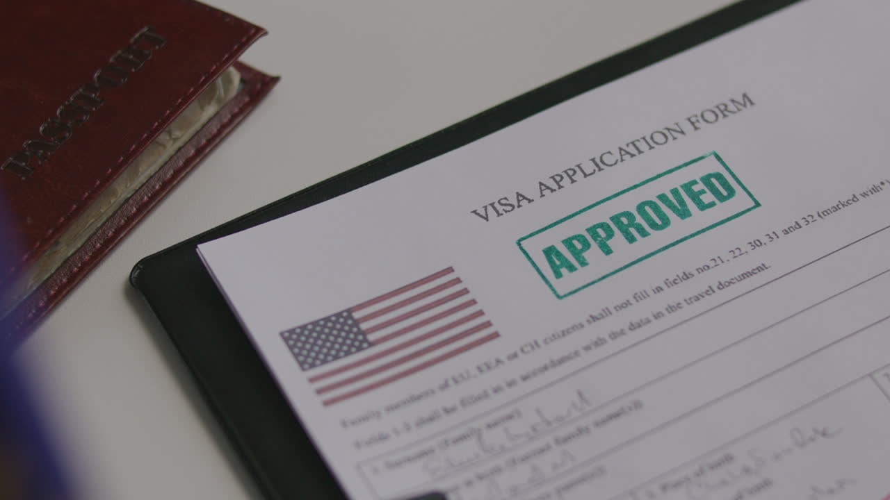 Close-Up of Approving US Visa Application Form with Green Stamp