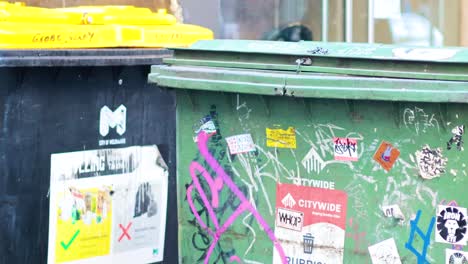 colorful bins with graffiti and stickers