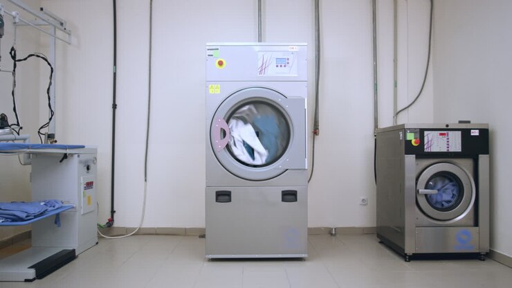 Industrial washer machine. Industrial laundry machine washing clothes