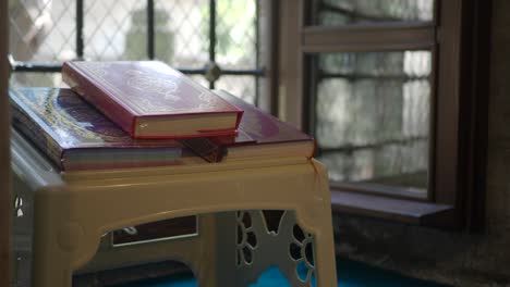 quran books on a table in a mosque