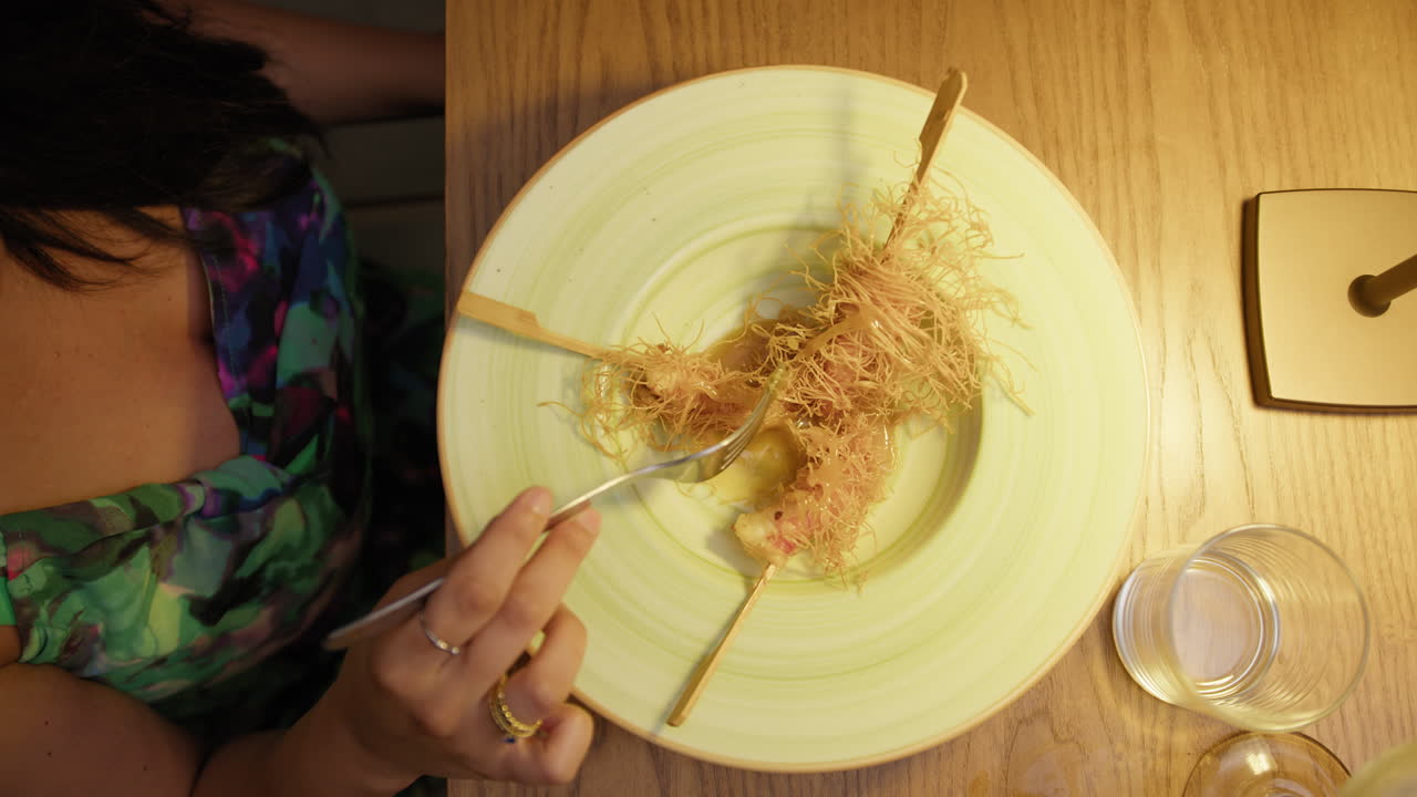 White Dish With A Gourmet Shrimp Recipe For A Woman Having Dinner