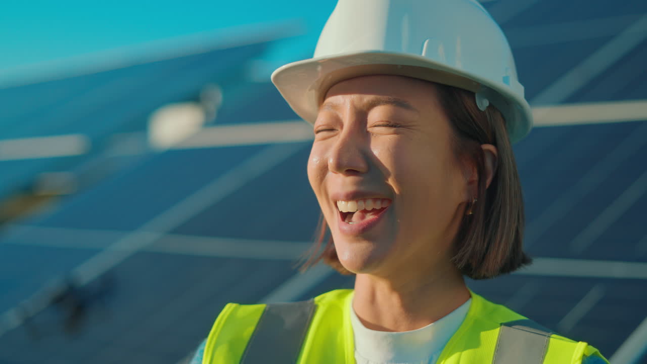 Asian female worker in solar panel construction site