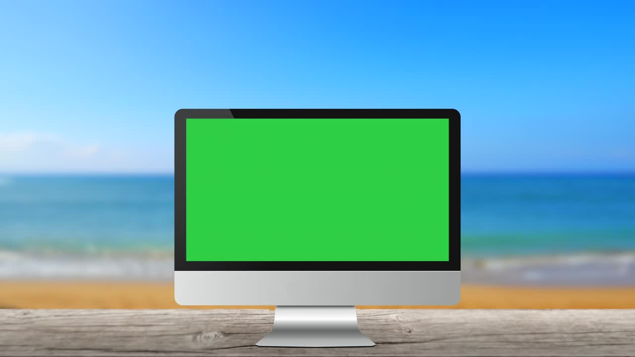 monitor de computadora moderno sin marca en la playa fondo marino pantalla verde en blanco