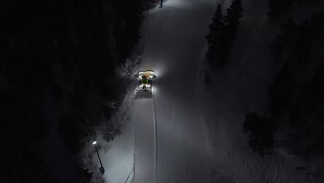 aerial of snow machine at work in idre, sweden during a late evening in the dark-3