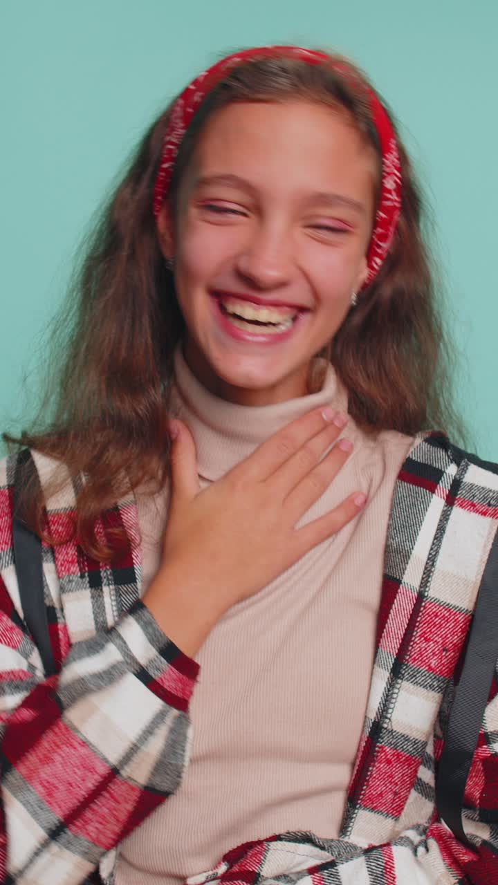 Happy positive child girl kid laughing out loud after hearing ridiculous anecdote funny joke