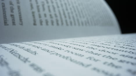 open book with white sheets against black background. new publishing book