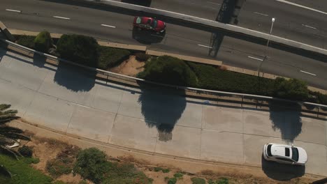 Afternoon-drone-view-from-a-slip-road-towards-to-the-Pacific-Coast-Highway-near-the-Santa-Monica-Beach,-California