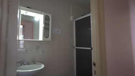 left camera slider clip captures the pristine shower and sink area in this minimalist airbnb bath. perfect for property highlights.