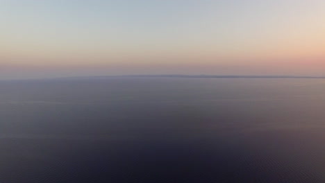 aerial waterscape with vast sea at sunset