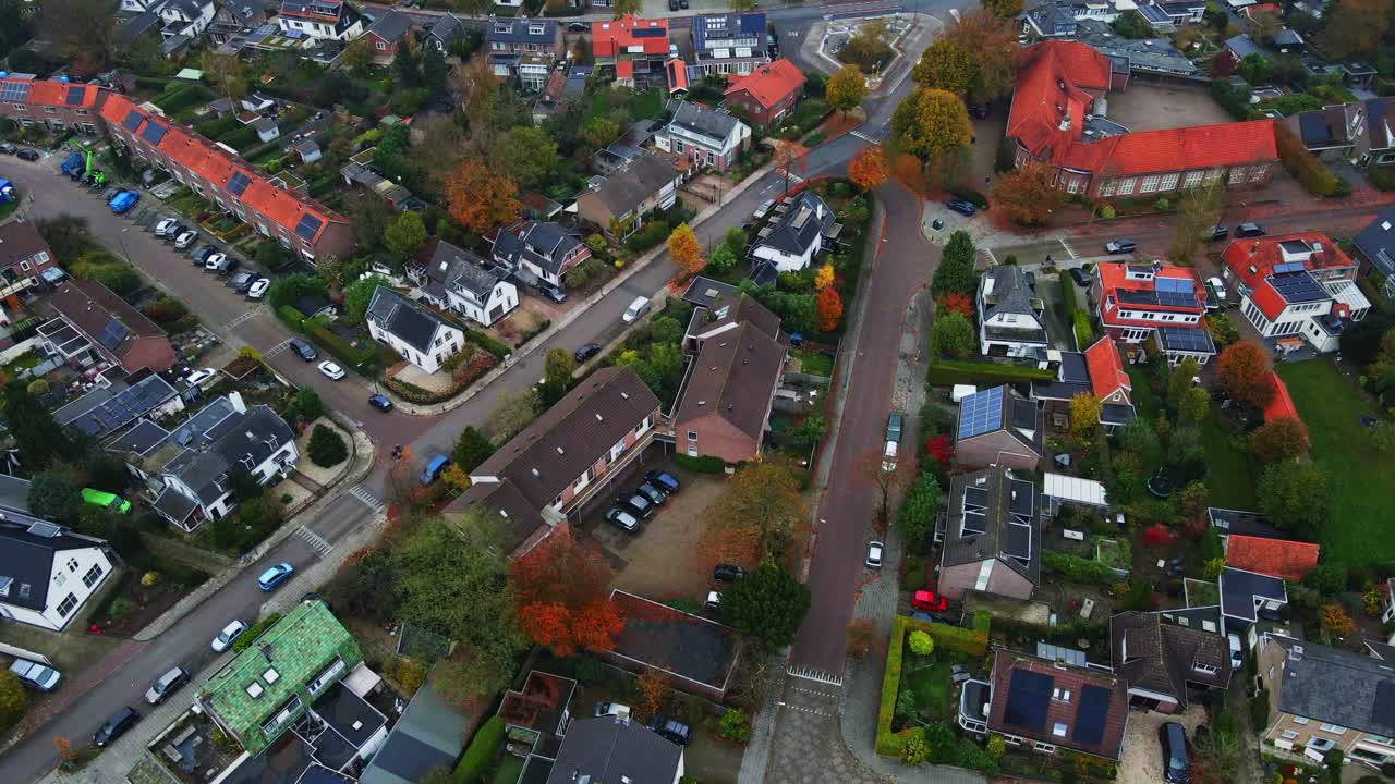 Beautiful aerial of traffic in a quiet neighborhood on an overcast autumn day