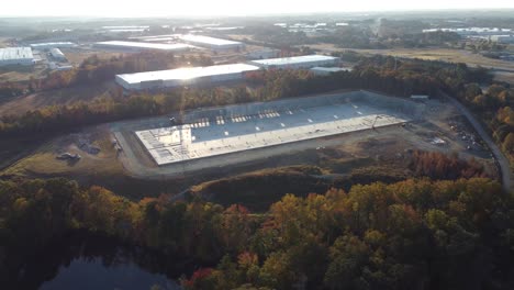 an ultra-wide shot of a drone showing off the entirety of a construction site in the morning with a heavy crane on site